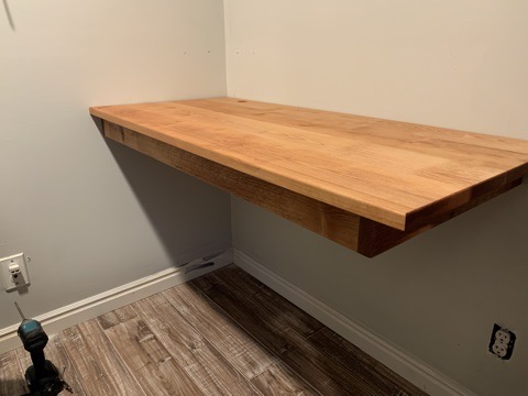 Floating wall shelf — solid wood, installed